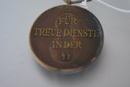 A German Third Reich bronze long service medal, eight years with the SS, "Fur Treue Dienst..".