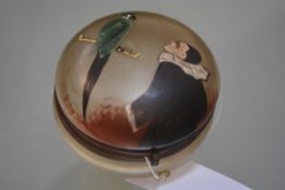 A Continental enamel painted glass powder jar, c. 1930, the cover painted with a Pierrette and