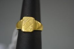 An Indian yellow metal signet ring, probably high carat gold, the rectangular plaque on a tapering