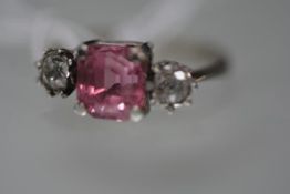 An early 20th century pink tourmaline and diamond three stone ring, the square cut tourmaline set