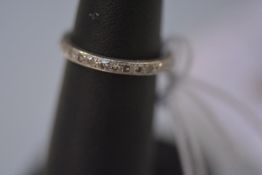 A full hoop diamond eternity ring or wedding band, channel set with a band of brilliants in (