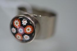 A 1970's 18ct white gold ring set with a millefiori glass cabochon of Caithness type. 14.6 grams