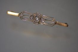 An early 20th century diamond-set bar brooch, the central panel with seven graduated round