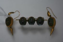 A suite of late Victorian gilt-metal mounted scarab jewellery, comprising a pair of drop earrings