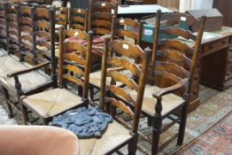 A set of seven Lancashire ladderback elm dining chairs, comprising a pair of carvers and five side