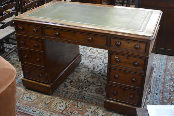 A Victorian mahogany pedestal desk, the leather-inset rectangular top with rounded corners above
