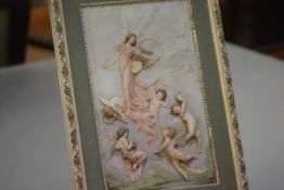 A Continental bisque porcelain high relief plaque, possibly Austrian, modelled as a musical