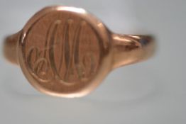 A 9ct gold signet ring, the circular plaque engraved with a monogram. 2.6 grams