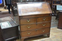 An early George III walnut bureau, the slant front opening to a fitted interior, and a well
