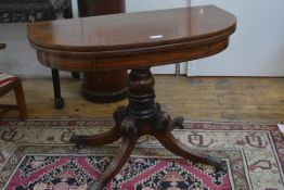 A George IV mahogany foldover tea table, the D-end top with ebonised string inlay, swivelling to