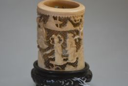 A Chinese tusk section ivory brush pot, Canton, 19th century, carved in relief with ladies in a