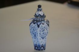 A Villeroy & Boch Delft vase and cover, early 20th century, of faceted baluster from, painted with