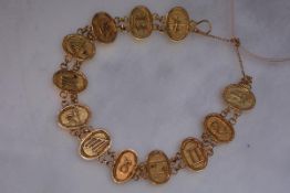 A Nigerian yellow metal (unmarked) bracelet, composed of linked oval panels, each decorated with a