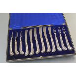 A cased set of six George V silver pistol-handled fruit knives and forks, Sheffield 1910, in their