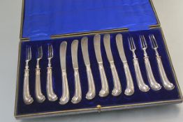 A cased set of six George V silver pistol-handled fruit knives and forks, Sheffield 1910, in their