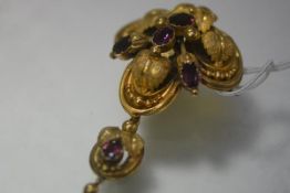 A Victorian purple garnet brooch, c. 1850, of three lobed form, modelled as leaves and berries and