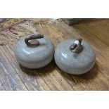 A pair of granite curling stones, c. 1900, each with brass-mounted ebonised wooden handle.