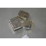Three silver vesta cases: the first with foliate engraving, Birmingham 1899; the second, smaller,