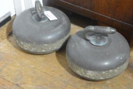 A pair of late 19th/early 20th century granite curling stones, with metal-mounted turned wooden