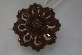 An Austro-Hungarian garnet brooch, late 19th century, of domed flowerhead form, set with stones of