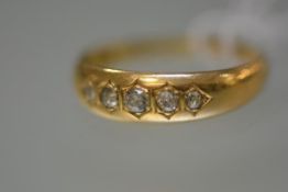 A late Victorian five stone diamond ring, the graduated stones "gypsy"-set in a tapering 18ct yellow