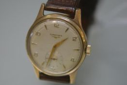 A Longines gentleman's yellow metal wristwatch, c. 1960, the circular dial with Arabic and baton