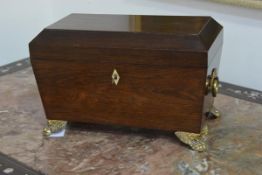 A Regency rosewood sarcophagus tea caddy, opening to three lidded compartments, each with turned