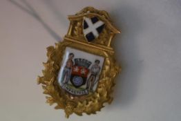 A 9ct gold and enamel civic brooch, centred by an enamel shield depicting the arms of Motherwell,