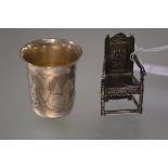 A Russian silver vodka cup or measure, late 19th century, engraved with cartouches of buildings