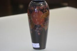 A William Moorcroft pottery vase, in the Pomegranate pattern, of tapering form, painted and