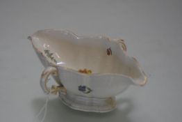 A Ludwigsburg porcelain sauceboat, 18th century, double lipped and twin handled, moulded and painted