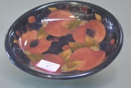 A William Moorcroft shallow dish, in the Pomegranate pattern, painted signature and impressed