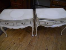 A pair of 1950's/60's gilt-highlighted cream-painted bedside tables, bowfronted, each with two