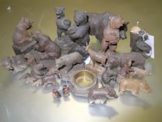 A group of Black Forest wooden bear and other animal models, including spill holders, pin cushion,