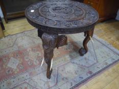An Anglo-Indian carved rosewood occasional table, early 20th century, the circular top carved in
