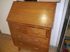 A 1950's mahogany bureau, on splayed legs. 108cm by 78cm by 46cm