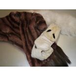 A vintage mink stole with tail tassels; together with a small ermine stole; and a white fur stole (