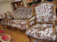 A Napoleon III style giltwood three piece salon suite, the sofa with shell carved crest rail and