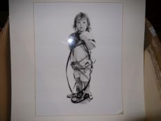 Nigel Fisher, a black and white photographic portrait of a child with a camera, signed on the mount,