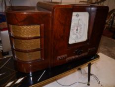 A Defiant walnut cased valve radio c. 1930/40, with Art Deco styling, 48cm x 78cm x 32cm