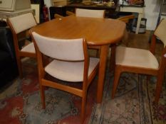 A 1970's vintage Danish teak D-Scan dining table and chairs, the extending table with rounded