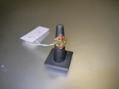 A yellow sapphire and diamond plaque ring, the lozenge shaped plaque set with concentric bands of