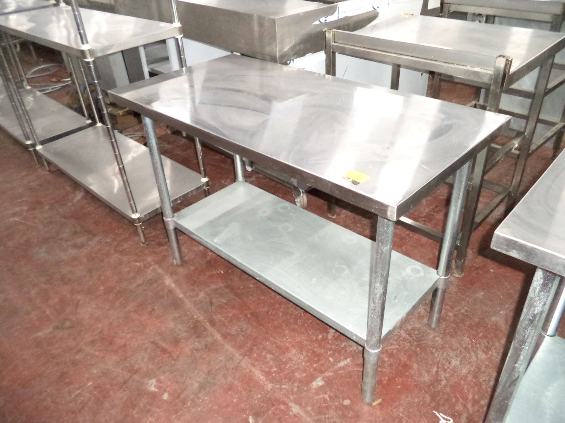 Stainless steel twin-tier table IMPORTANT: Please remember goods successfully bid upon must be