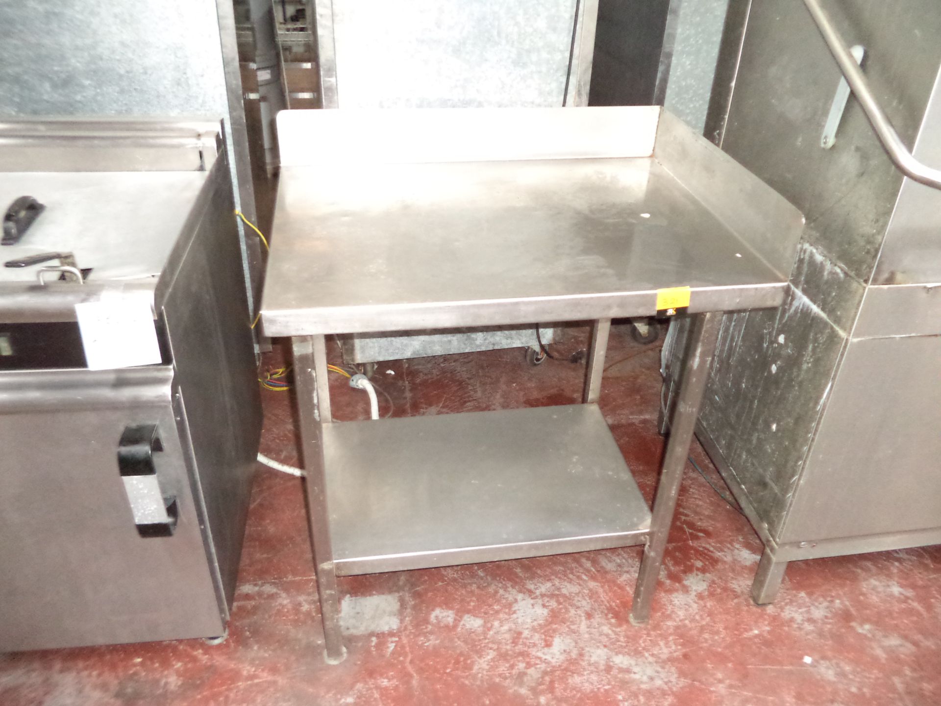 Stainless steel twin-tier table IMPORTANT: Please remember goods successfully bid upon must be