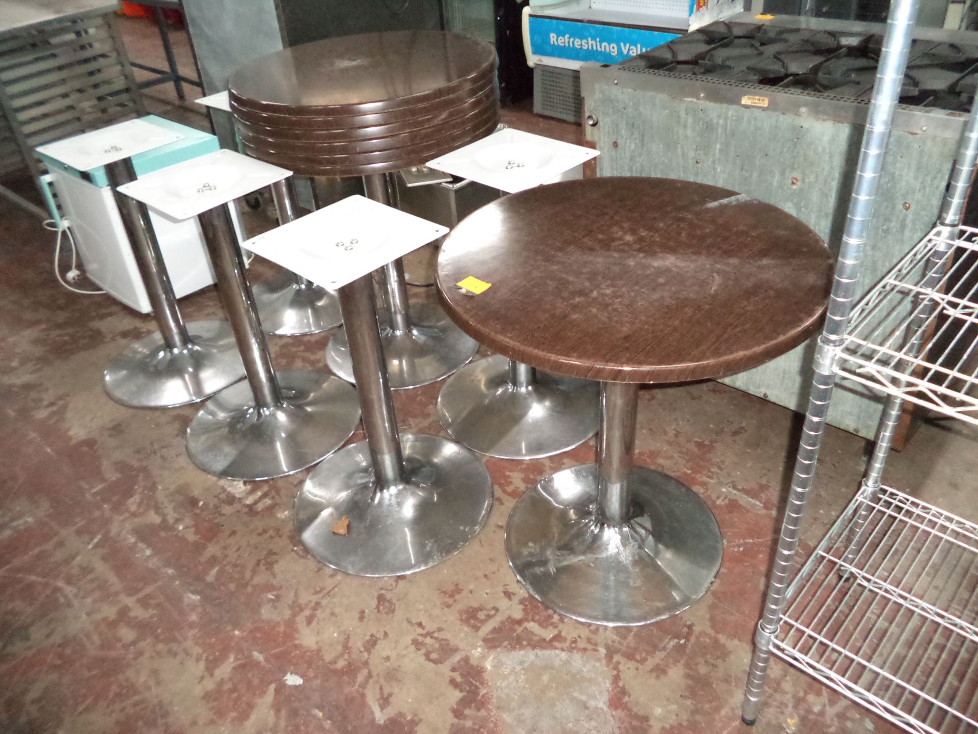 Quantity of formica-style topped brown round tables, diameter 700mm, consisting of 7 pedestals and 7