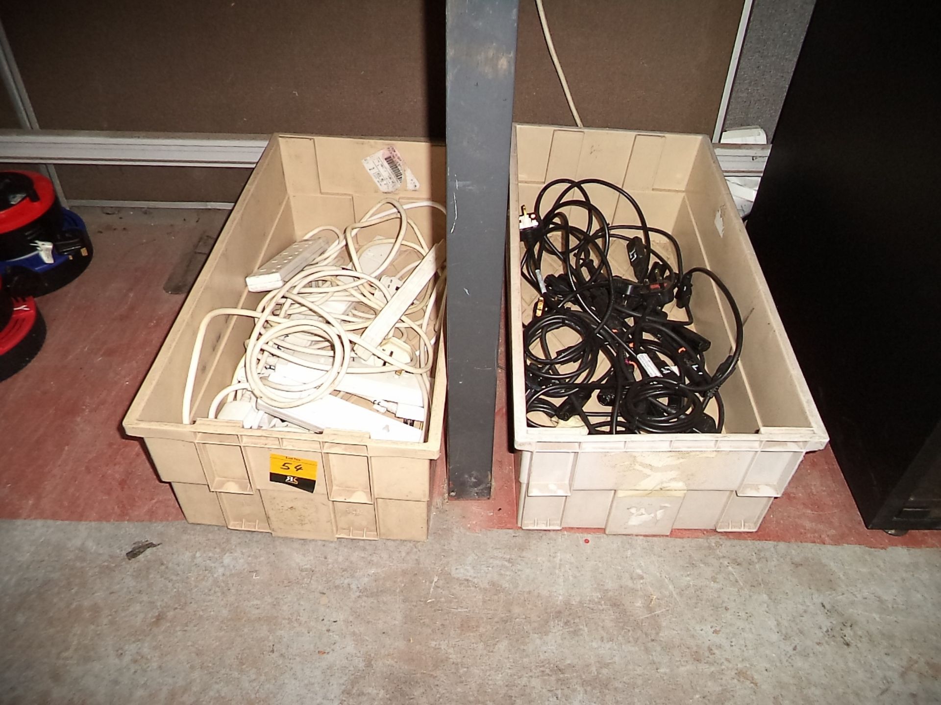 Contents of a crate of multi way power adaptors plus the contents of a crate of assorted power leads