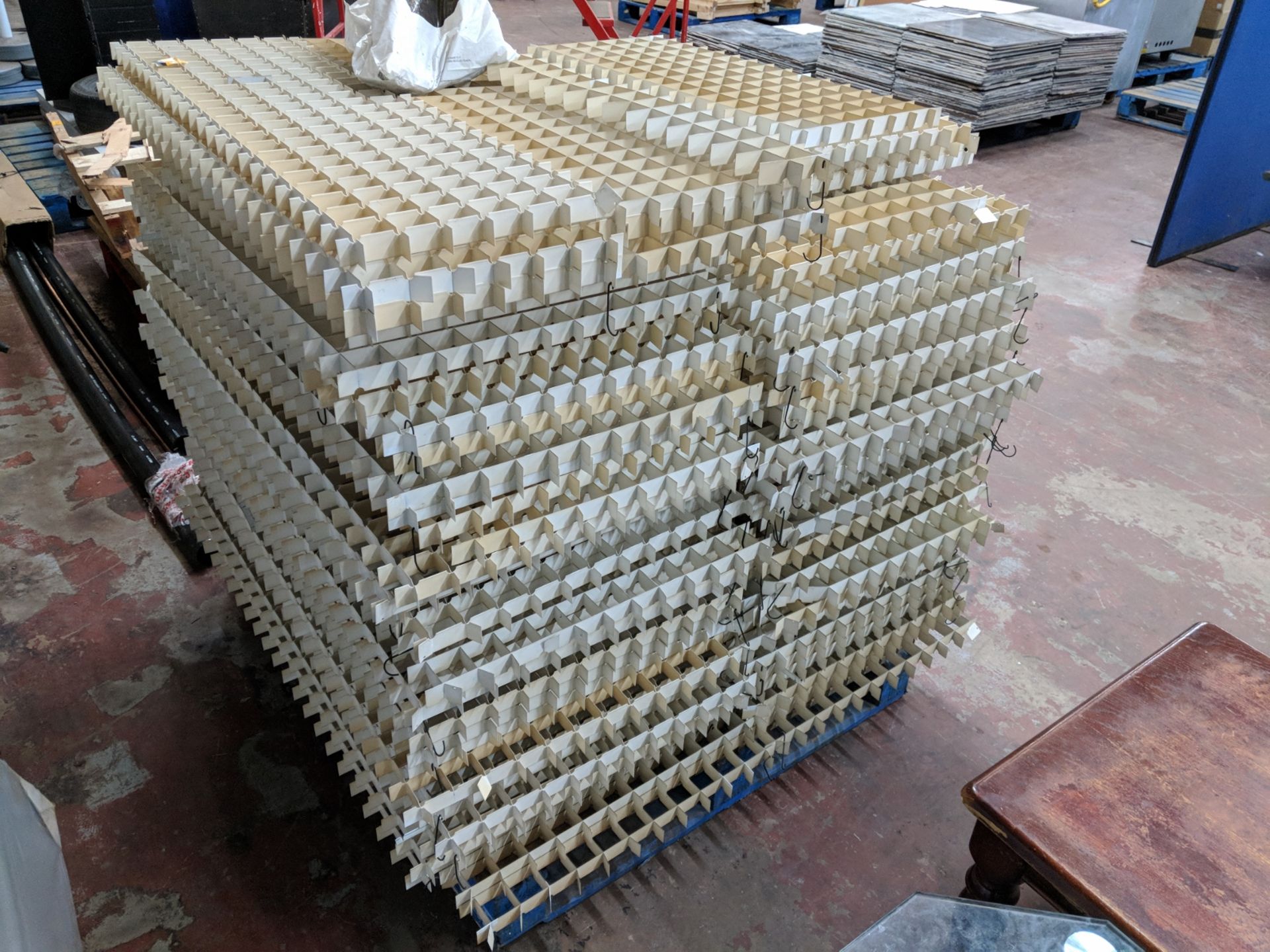 The contents of a pallet of suspended ceiling/lighting panels, believed to be coated aluminium,