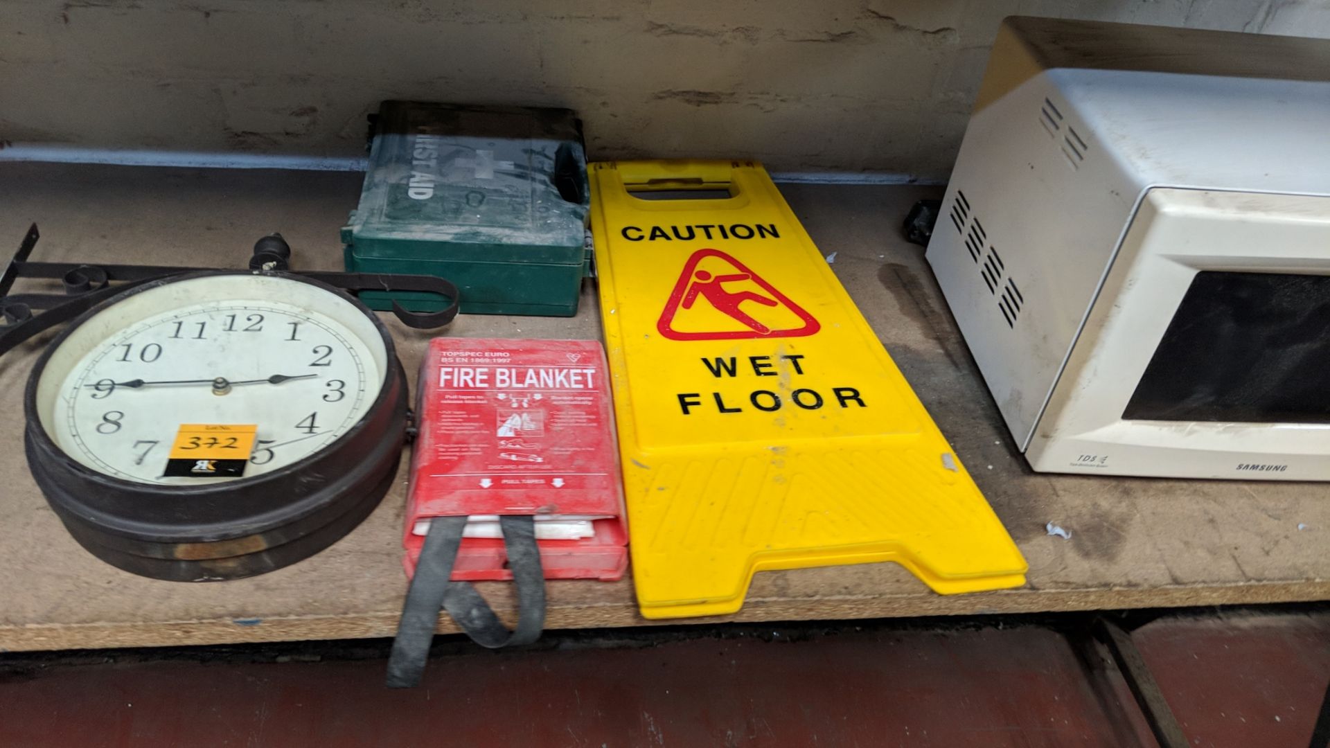 Mixed lot comprising traditional style clock plus first aid kit, fire blanket, "Wet Floor" sign - Image 3 of 4