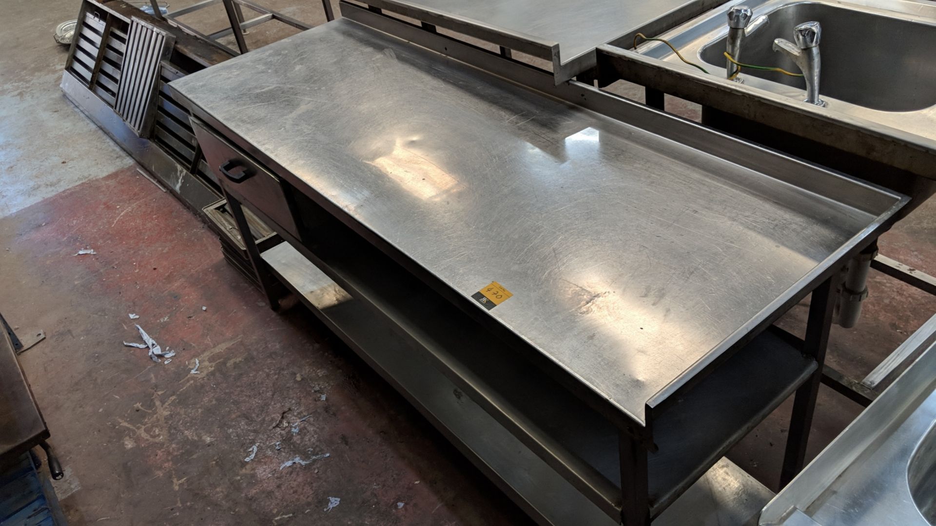 Stainless steel triple-tier table including built-in drawer, circa 1800mm long IMPORTANT: Please