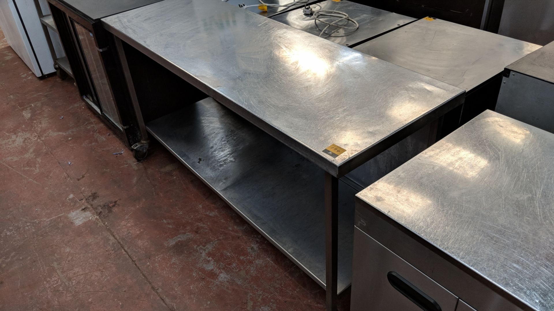 Large stainless steel mobile twin-tier table measuring circa 1800mm x 600mm x 900mm IMPORTANT: - Image 2 of 2